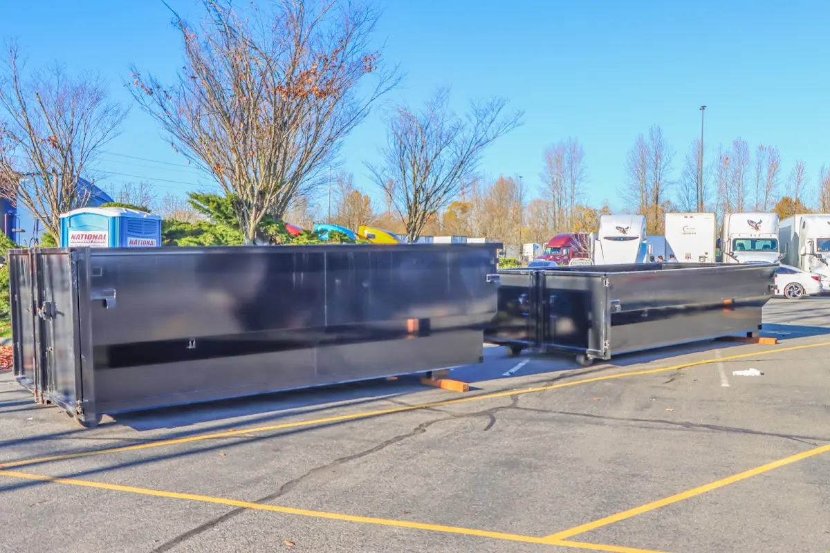 Professional dumpster rental service with roll-off container on residential driveway in Philadelphia